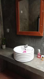 a white sink in a bathroom with a mirror at Fruit Garden Resort Sigiriya in Sigiriya +22 photos