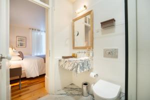 a bathroom with a sink and a toilet in a room at Once Upon Lisboa in Lisbon +37 photos