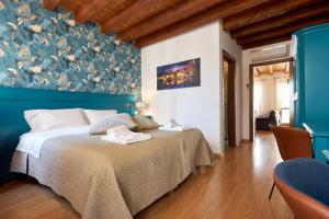 a bedroom with a large bed with a blue wall at Residence "Professor's nest" - Verona Apartments in Verona