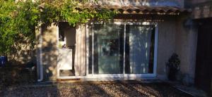 a front door of a house with a window at Studio La Cheneraie in Bargemon