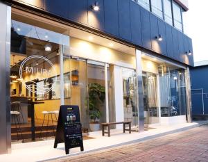 a store window with a bench in front of it at TAP Inn MIURA in Miura