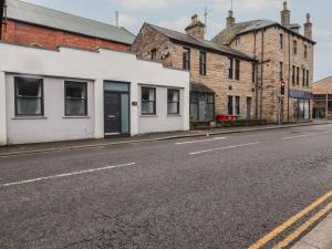 an empty city street with buildings and a traffic light at 20 Lorton Street in Cockermouth
