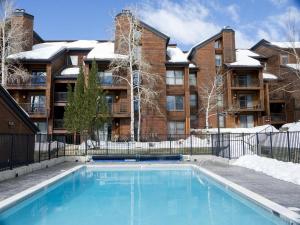a swimming pool in front of a building at Hot tubs and pool -Looping shuttle- Cozy fireplace in Steamboat Springs