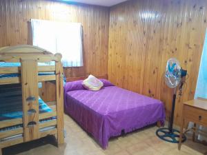 a bedroom with a bunk bed and a fan at Arevalo Mar de Ajo in Mar de Ajó