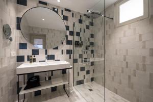 a bathroom with a sink and a mirror at Tandem Mezquita in Córdoba +37 photos