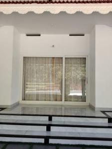 a white room with a window and some stairs at VLand homestay in Vagamon