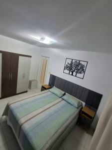 a bedroom with a large bed in a room at Cantinho da Ro in Balneário Camboriú