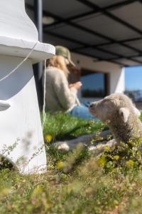 two people sitting in the grass with a stuffed animal at Estancia TATAY in Trelew