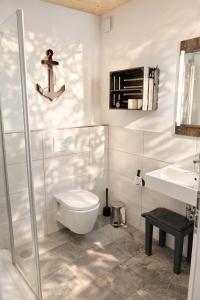a bathroom with a toilet and a sink at Ankerix & Deichfix in Büsum +35 photos