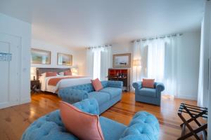 a living room with a bed and a blue couch at Once Upon Lisboa in Lisbon