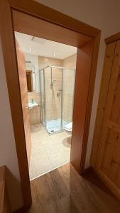 a bathroom with a shower and a glass door at Terra Rossa in Fiss +72 photos