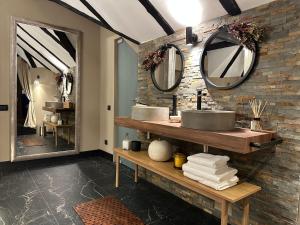 a bathroom with two sinks and mirrors on the wall at Relax in Style Boutique Hotel in Braşov