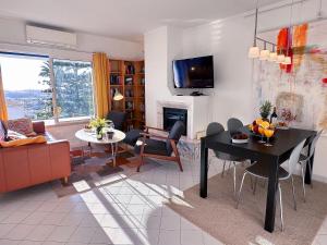 a living room with a table and a fireplace at WindMill Rooftop Panoramic OceanView Condo By BeCherish in Albufeira