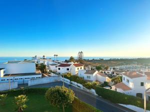 an aerial view of houses and the ocean at WindMill Rooftop Panoramic OceanView Condo By BeCherish in Albufeira
