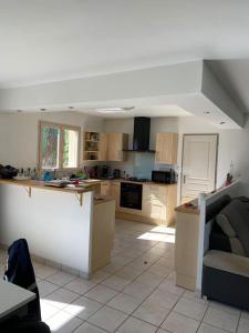 a kitchen with a couch and a table in it at Chambre de maison de campagne in Uzerche