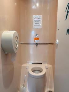 a small bathroom with a toilet with a paper dispenser at hotelF1 Brest Sud Plougastel in Plougastel-Daoulas