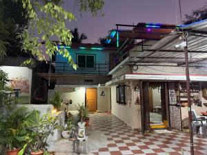 a house with a checkered floor in front of it at Shankar Homestay in Hampi