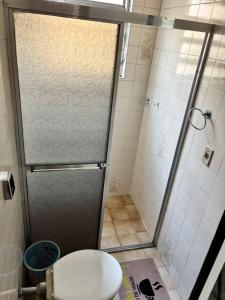 a shower stall with a toilet in a bathroom at Six's Hotel in Jacareí