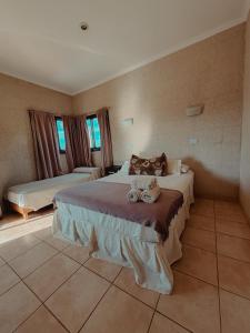a bedroom with a large bed with towels on it at Complejo La Yema in Miramar +57 photos