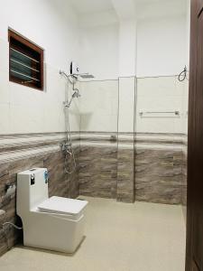 a bathroom with a toilet and a glass shower at Double T in Dickwella +48 photos