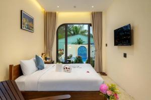 a bedroom with a bed and a large window at SEAESTA An Bang in An Bàn (2)