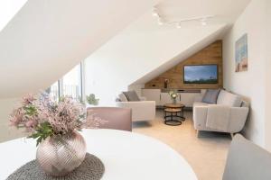 a living room with a vase of flowers on a table at Dahmer Strand 5 in Dahme