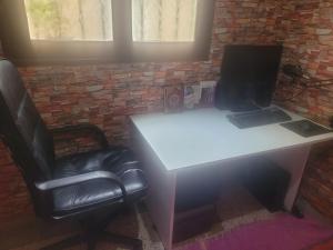 a white desk with a laptop and a chair at بيت مع وجبة إفطار لمشجعي كأس الأمم الأفريقية in Fez