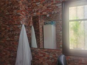 a mirror on a brick wall with a surfboard at بيت مع وجبة إفطار لمشجعي كأس الأمم الأفريقية in Fez