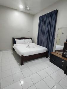 En eller flere senge i et værelse på Homestay Melaka Baitul Saadah