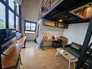 een woonkamer met een bank en een tafel bij ชวนไดอารี่ Chuan Diary in Ban Nong Bua