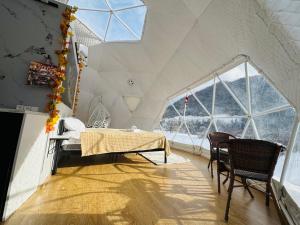 a room with a bed and a table in a tent at Buddy glamping Borjomi in Borjomi