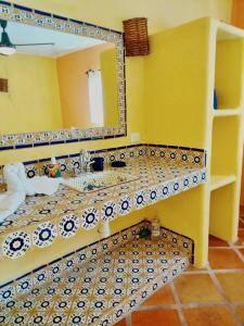 a bathroom with a sink and a mirror at Estrella - Casa MoJo's airy 2BR, kitchen, pool in Sayulita +8 photos