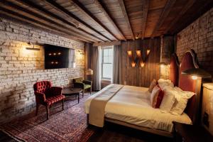 a bedroom with a bed and a brick wall at The Wildings Northumberland in Morpeth