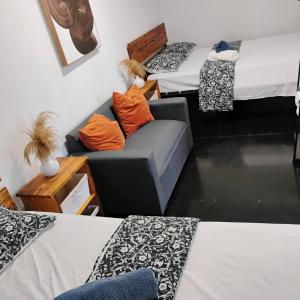 un salon avec deux lits et un canapé dans l'établissement Beachside 1BR Apartment Sleeps 4, à Vega Baja