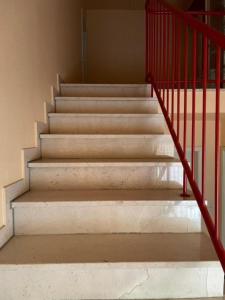 a set of stairs with a red railing at Ferienwohnung Hoher Pön in Willingen