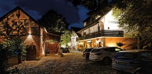 a street with cars parked in front of a building at Landgasthaus & Hotel Lindenhof in Königslutter am Elm
