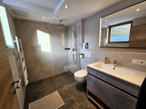 a bathroom with a sink and a shower and a toilet at Apartment Gerlos 183 in Gerlos +28 photos
