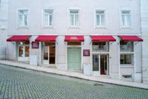 a facade of a building with red awnings at Once Upon Lisboa in Lisbon