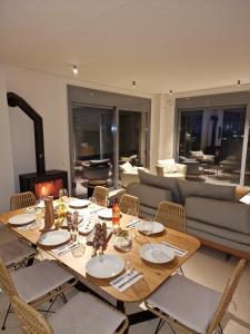 a dining room with a table and a couch at Seeview Villa and Mountain view in Grizókambos