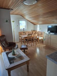 a living room with a table and a dining room at Berghaus Edelstein in Bodenmais in Bodenmais