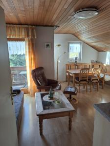a living room with a couch and a table at Berghaus Edelstein in Bodenmais in Bodenmais