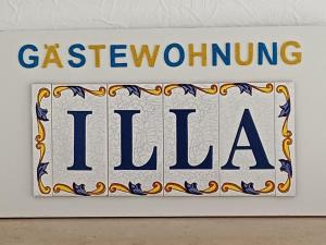 a sign for a gashgiving illia on a wall at Gästewohnung Illa in Meerbusch
