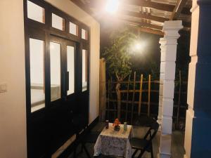 a table and chairs in a room with a window at Nimal's villa in Midigama East