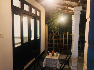a table and chairs in a room with a window at Nimal's villa in Midigama East +9 photos