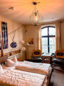 a bedroom with two beds and a chandelier at Pension Spreewelten in Lübbenau