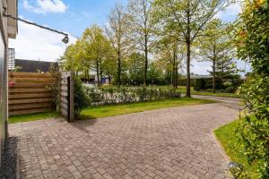 a driveway with a gate and a fence at Bed and breakfast Stiens in Stiens