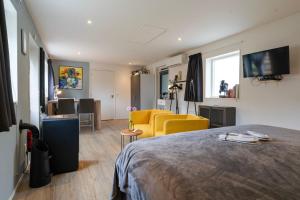 a bedroom with a bed and a living room at Bed and breakfast Stiens in Stiens