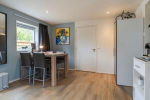 a kitchen and dining room with a table and chairs at Bed and breakfast Stiens in Stiens
