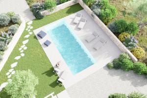an overhead view of a swimming pool in a backyard at Pavì Trulli e Suites in Locorotondo
