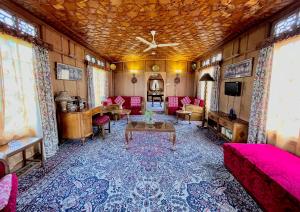 a living room with a couch and a table at Vanda Heritage Houseboats in Srinagar